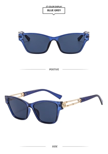 Detail of blue grey cat eye sunglasses with gold hollow metal temples and spiral accents
