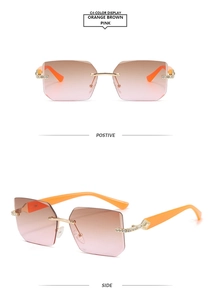 Détail de lunettes de soleil sans monture avec strass étincelants sur les branches oranges