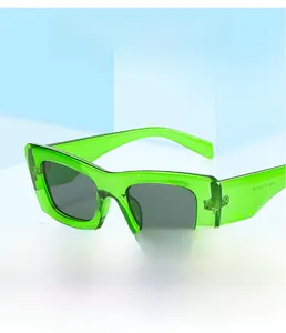 Macro view of square frame sunglasses with green translucent finish and temple details