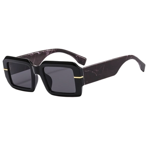 Modern square black sunglasses with gold metal trim and purple marble textured temples
