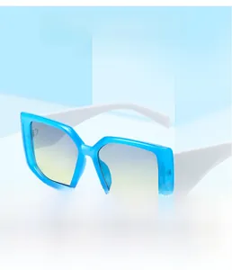 Detail of square candy-colored sunglasses with blue frames and white temples