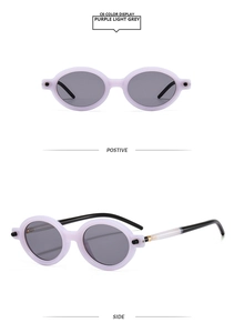 Détail des lunettes de soleil ovales mauves avec verres gris et branches noir et blanc