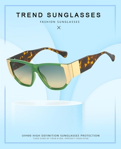 Detail of square green frames with gold hardware and UV400 gradient lenses