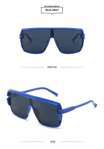 Detail view showing front and side profile of blue oversized wrap sunglasses