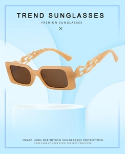 Detail of cream rectangle sunglasses with unique hollow flame texture on the temples