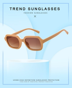 Detail of square frame sunglasses showing UV400 gradient lenses on a display stand