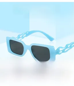 Detail view of light blue square frame sunglasses with unique flame-shaped cutout temples