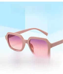 Detail of pink square sunglasses with gradient lenses against a blue background
