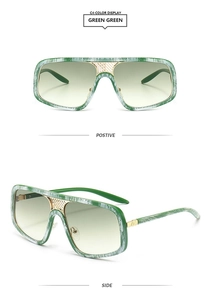 Details einer quadratischen Oversize-Sonnenbrille mit grüner Holzmaserung und Goldsteg