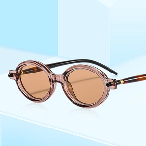 Lunettes de soleil ovales rétro avec monture ambre translucide et branches écaille