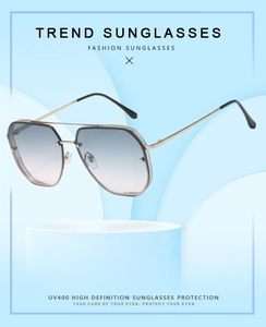 Detail view of gold metal pilot sunglasses with gradient lenses and UV400 protection
