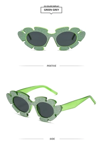 Detailansicht der hellgrünen Sonnenbrille in Blattform mit glitzerndem Finish und grauen Gläsern