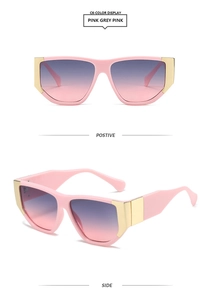 Close-up of pink thick square frame sunglasses with golden metal hinges and gradient lenses