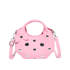 Pink crescent underarm bag with silver studs and bow detail on polished faux leather
