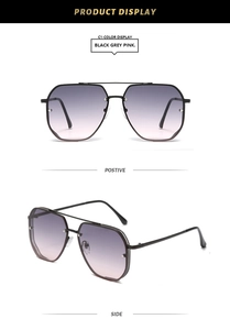 Detail of aviator sunglasses with black metal double bridge and grey-pink gradient lenses