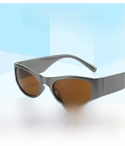Detail view of Y2K retro sunglasses with matte grey frames and translucent brown lenses