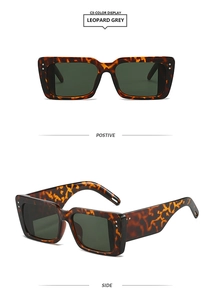 Detail view of leopard print rectangular sunglasses with silver rivets and green lenses