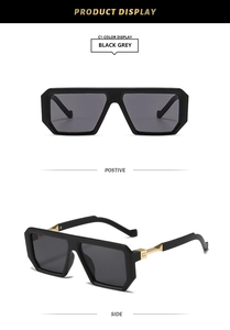 Detail view of square oversized black sunglasses with gold metal and acetate temples