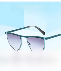 Detail of matte teal geometric sunglasses featuring gradient lenses and soft nose pads