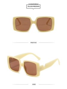 Detail view of cream rectangle sunglasses with brown lenses and geometric V-cut temples