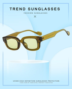 Détail de lunettes de soleil carrées vert olive avec verres jaunes et protection UV400