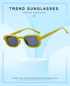 Detail of square mustard green sunglasses frame with UV400 grey lenses on a stand