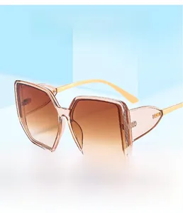 Detail view of square oversized sunglasses with brown gradient lenses and gold temples
