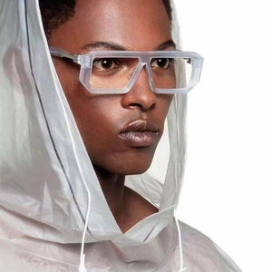 Futuristic square oversized sunglasses with translucent gray thick frames on a model