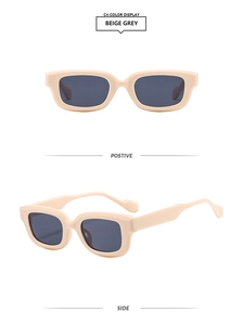 Détail de lunettes de soleil rectangulaires gris beige avec monture épaisse et verres gris