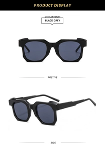 Detail view of black geometric sunglasses with grey lenses and shiny polygon frames