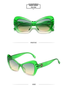 Detail of green cat-eye sunglasses with gold vintage patterns and gradient lenses