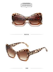 Detail of leopard print cat-eye sunglasses with golden hollow temple decorations