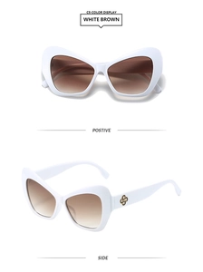 Cat eye sunglasses with white frame, brown gradient lenses and golden floral temple detail