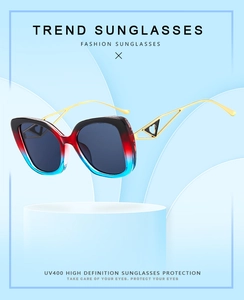 Detail of Y2K square sunglasses featuring red and blue gradient frames and UV400 lenses