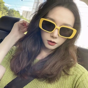 Fashionable yellow square frame sunglasses with black lenses for a luxury minimalist look