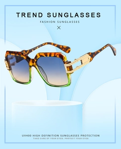 Detail of square oversized tortoise sunglasses with gradient lenses and gold metal temples