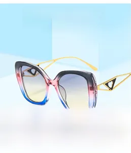 Close-up of golden metal temples with hollow triangle design and heart detail on sunglasses