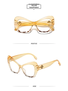 Detail of yellow transparent cat-eye sunglasses with golden logo and tortoise shell pattern