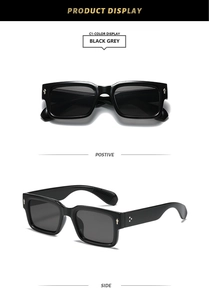 Detail view of black rectangular sunglasses with silver diamond studs and grey lenses
