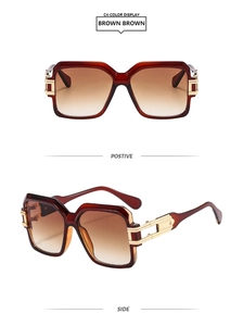 Detail view of square tortoiseshell sunglasses with gold metal hinges and gradient lenses