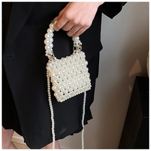 Detail view of handmade white pearl woven crossbody bag with elegant shoulder strap