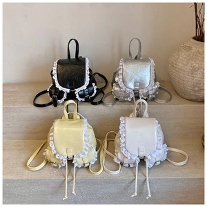 Detail of mini bucket backpacks in PU leather with white lace trim in four colors