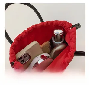 Detail view of red straw bucket bag interior showing spacious storage for essentials