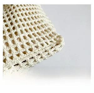 Detailed close-up of beige handmade woven tote bag mesh texture with fabric lining