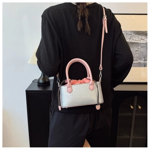 Detailed macro view of silver woven texture bucket bag with pink drawstring interior
