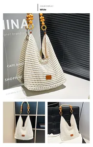 Detail of white crochet tote bag with wooden bead shoulder strap and leather patch
