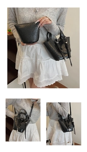 Detail of black crocodile texture bucket bag with metal lock and small zipper pouch