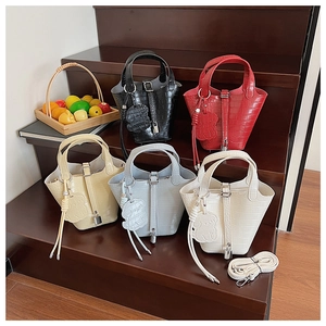 Detail of crocodile pattern bucket bags in five colors with cute bear charms