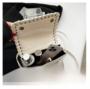 Top view of cream woven shoulder bag showing spacious interior for phone and cosmetics