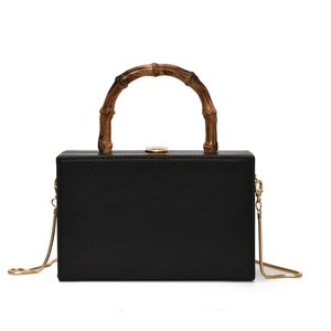 Retro black box handbag with bamboo handle and gold chain strap in a classic minimalist style